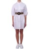 Abito Kocca donna ,modello camicia , con abbottonatura centrale nascosta, maniche a sbuffo con elastico al fondo e una cintura in paglia con fibbia tonda. Bianco Abito Kocca donna ,modello camicia , con abbottonatura centrale nascosta, maniche a sbuffo con elastico al fondo e una cintura in paglia con fibbia tonda. Bianco